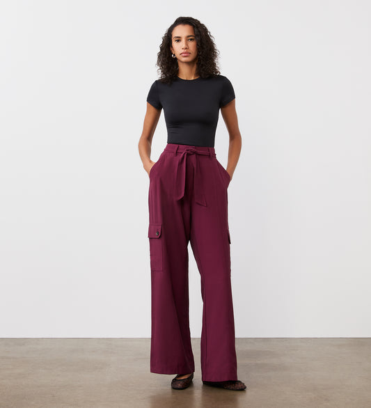 Full body view of a model wearing the Maxine Merlot Wide Leg Trousers facing forward.