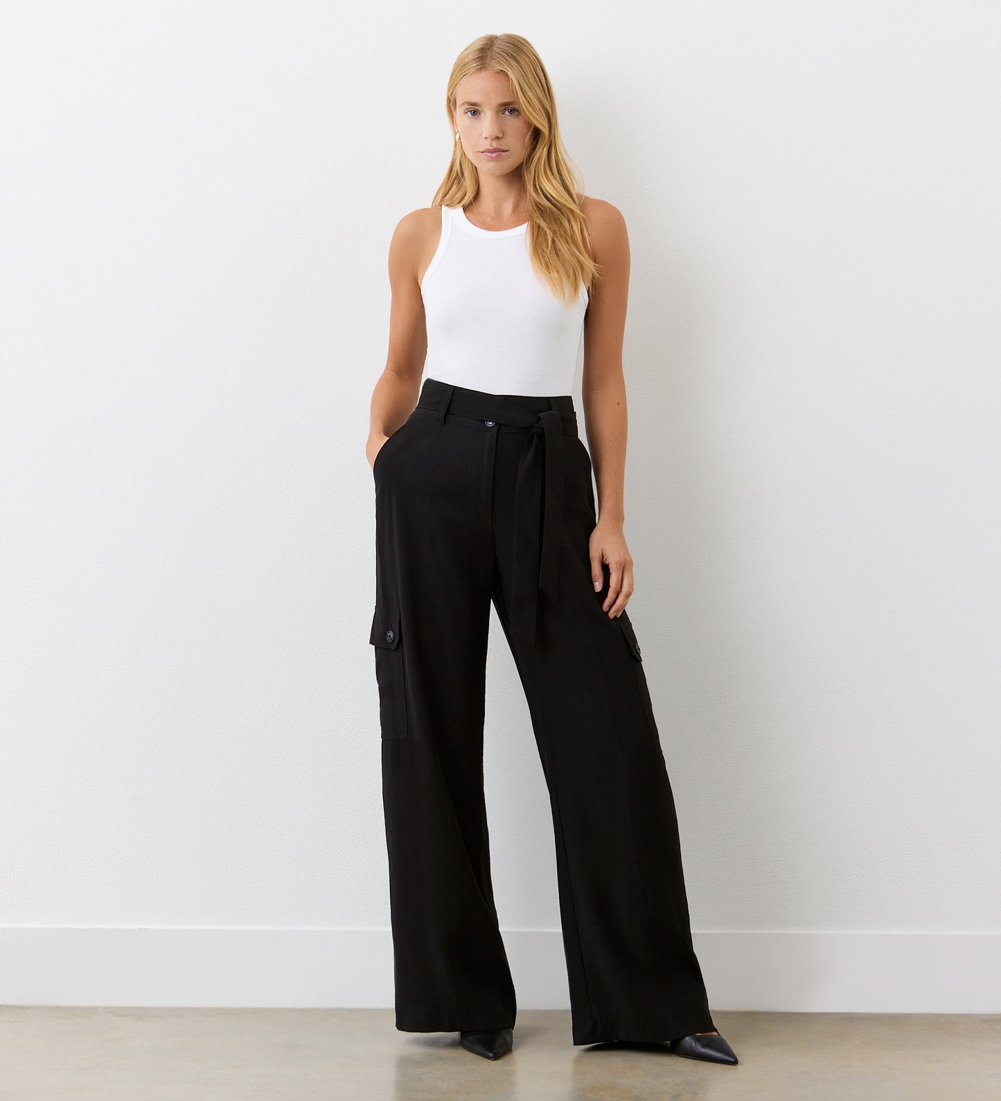 Full body view of a model wearing the Maxine Black Wide Leg Trousers facing forward.