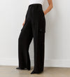 Close-up view of a model wearing the Maxine Black Wide Leg Trousers facing side-on.