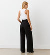 Full body back view of a model wearing the Maxine Black Wide Leg Trousers facing away from the camera.